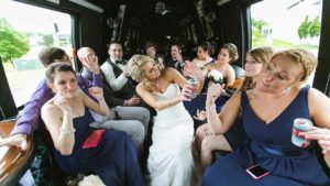 wedding party celebrating in limo