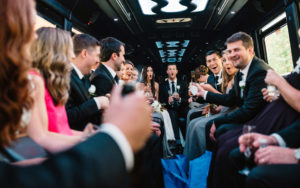 wedding party celebrating wedding in limo